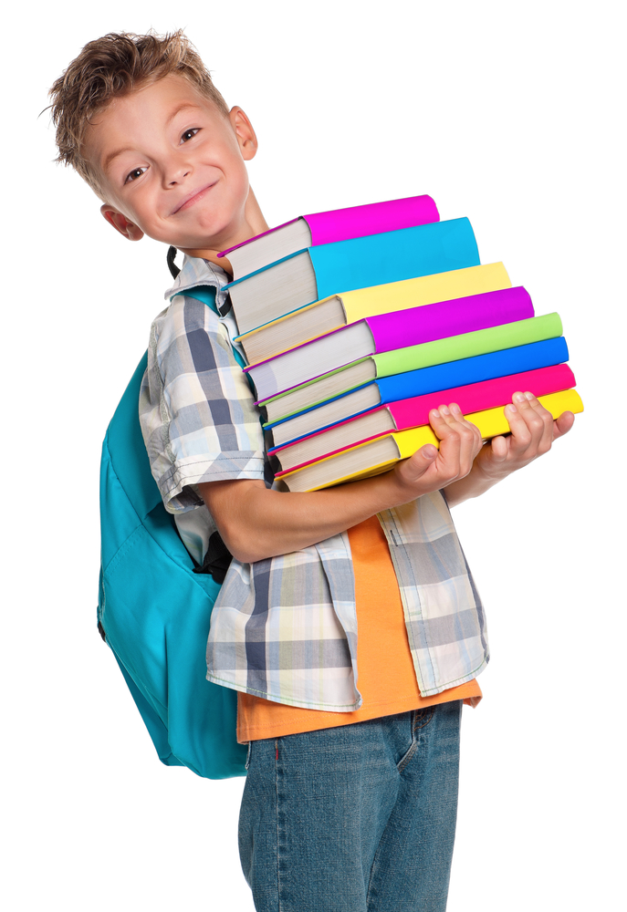 Happy schoolboy with backpack and books isolated on white background